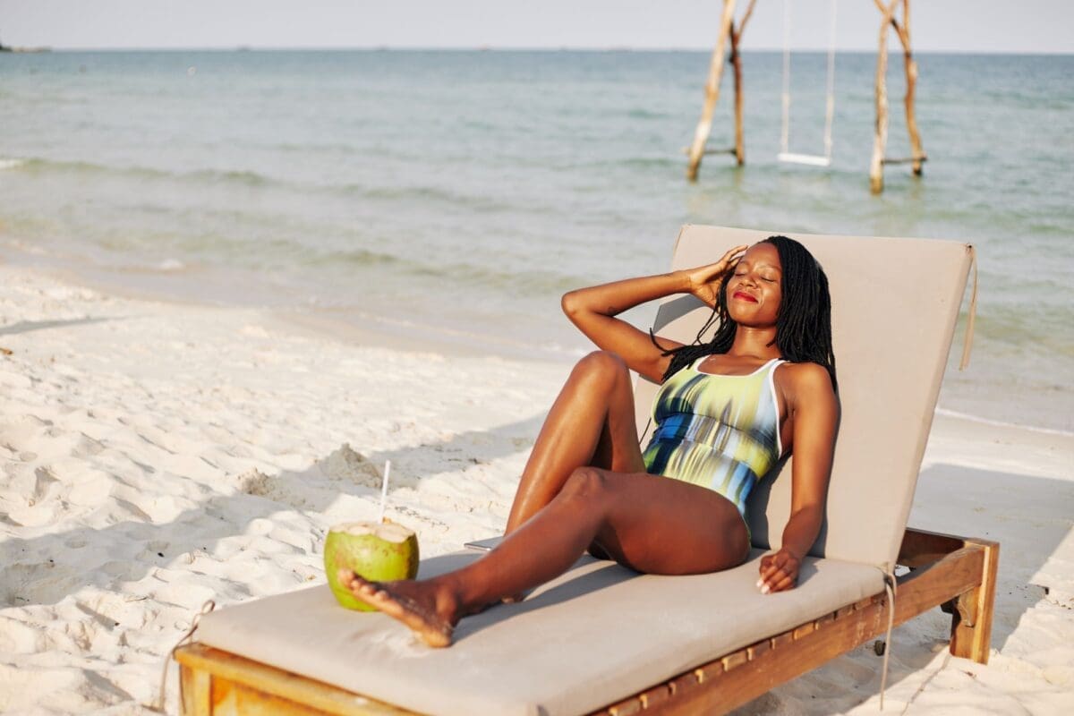 beautiful young woman Sunbathing by the beach-Top Things To Do In Diani