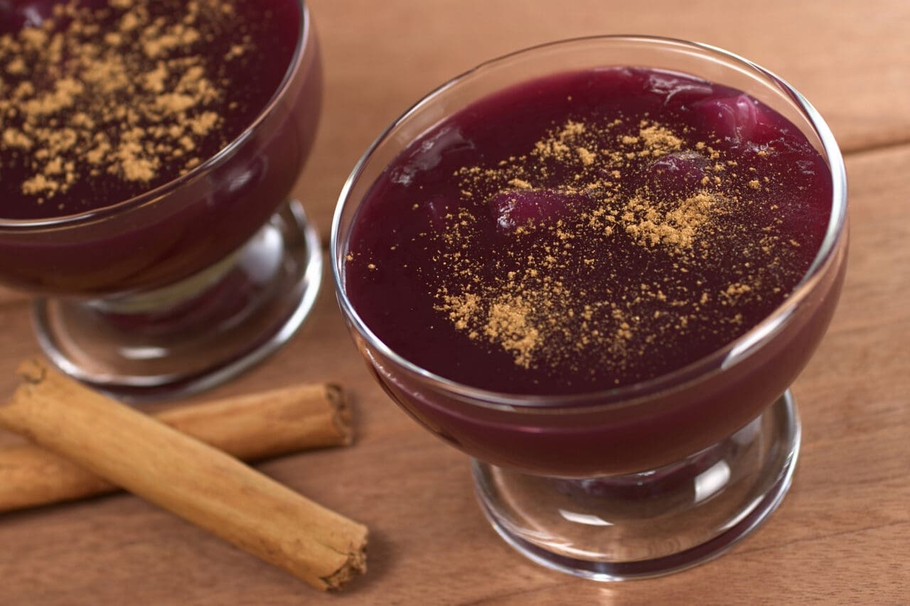 Popular Peruvian desserts Mazamorra Morada (made out of purple corn) with cinnamon sticks