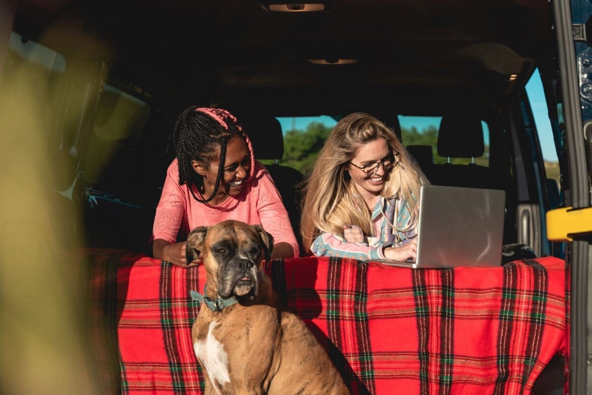 Multiracial people with dog traveling together mini van transport-Car Travel With Pets