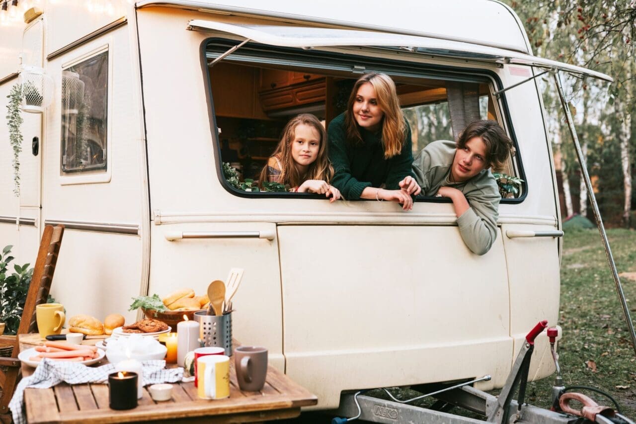 Three siblings children two sisters and older brother in trailer mobile home or recreational vehicle