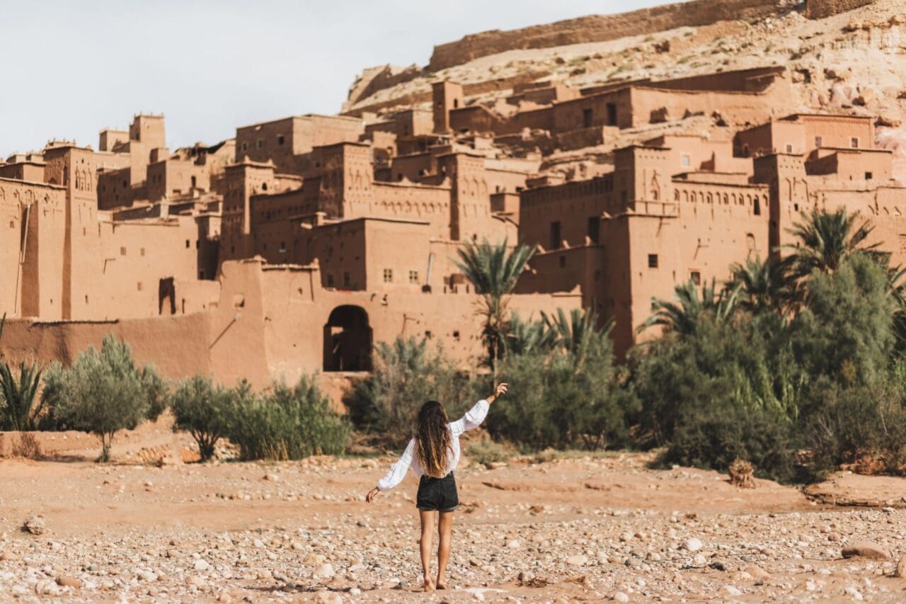 Woman enjoyiang popular landmark ksar Ait-Ben-Haddou, Morocco